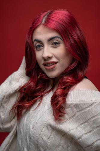 Local North East Newcastle upon Tyne Tracy James Photography studio photographer portrait headshot studio lighting lady with red hair with red background